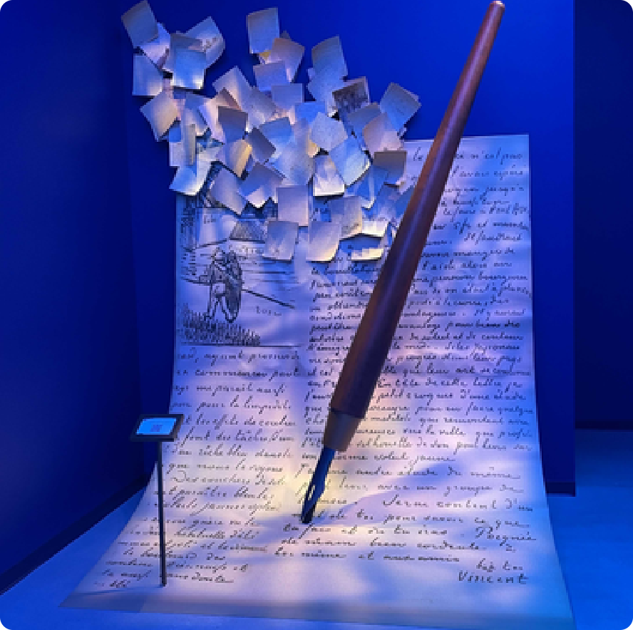 Sculpture of a giant pen writing a handwritten letter